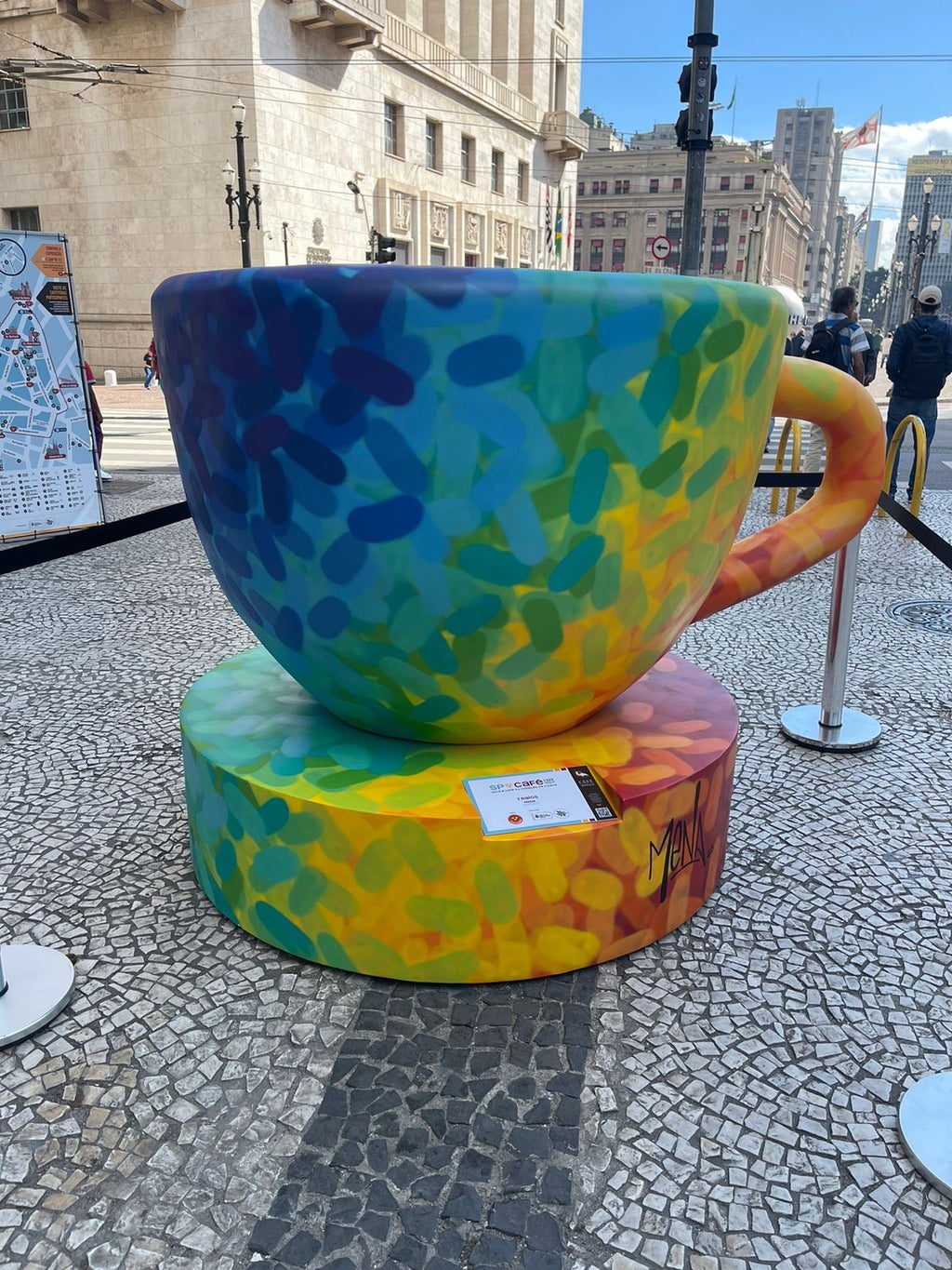 Coffee cup painted in rainbow collors placed near São Paulo City Hall.