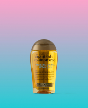 Bottle of hair product in front of an ombre pink and blue background