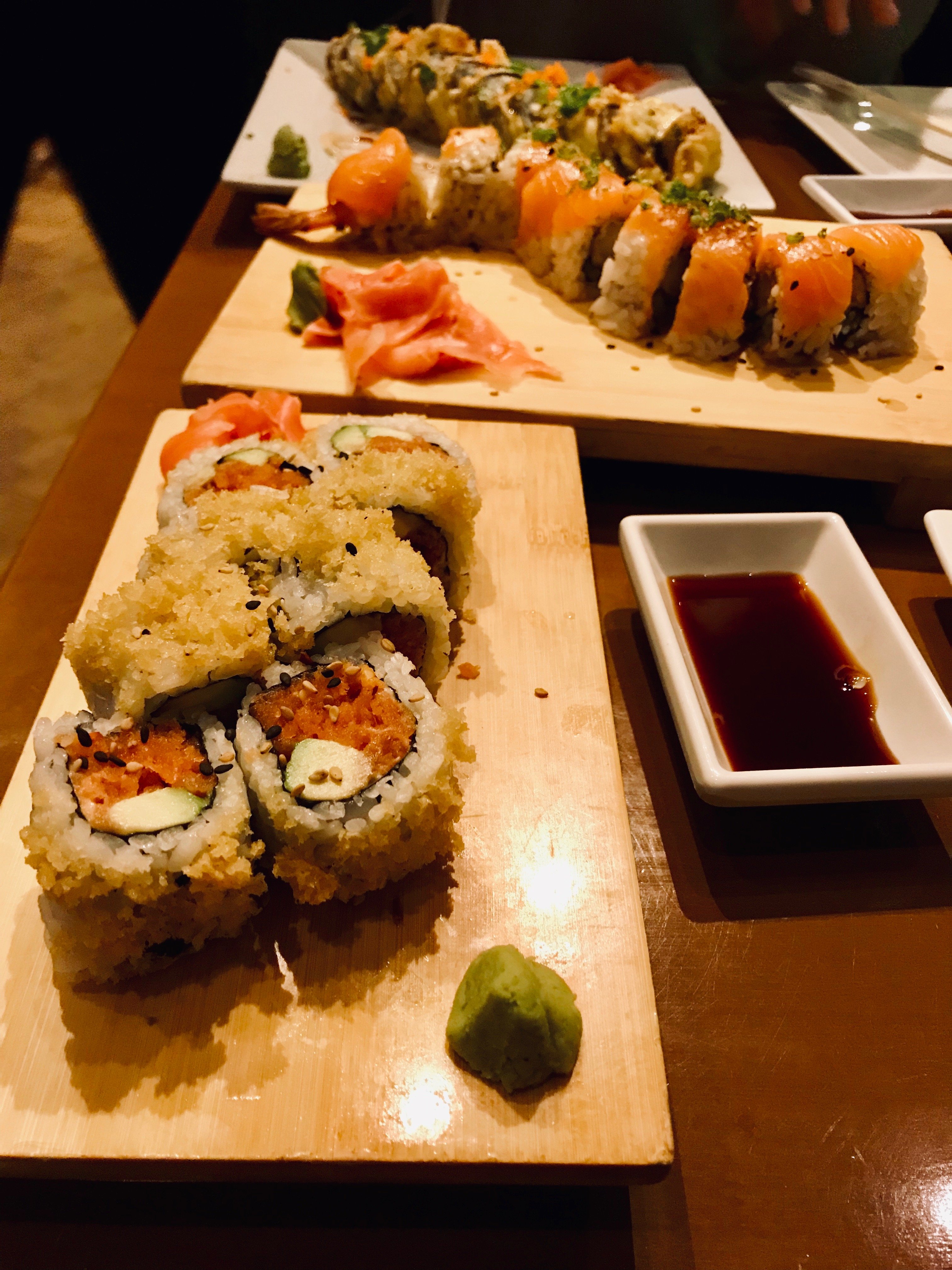 three rolls of sushi on three separate serving boards