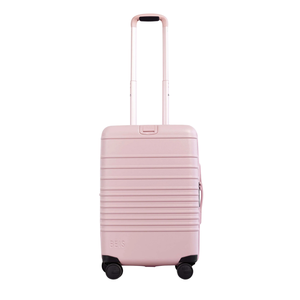 light pink hard-shell rolling suitcase