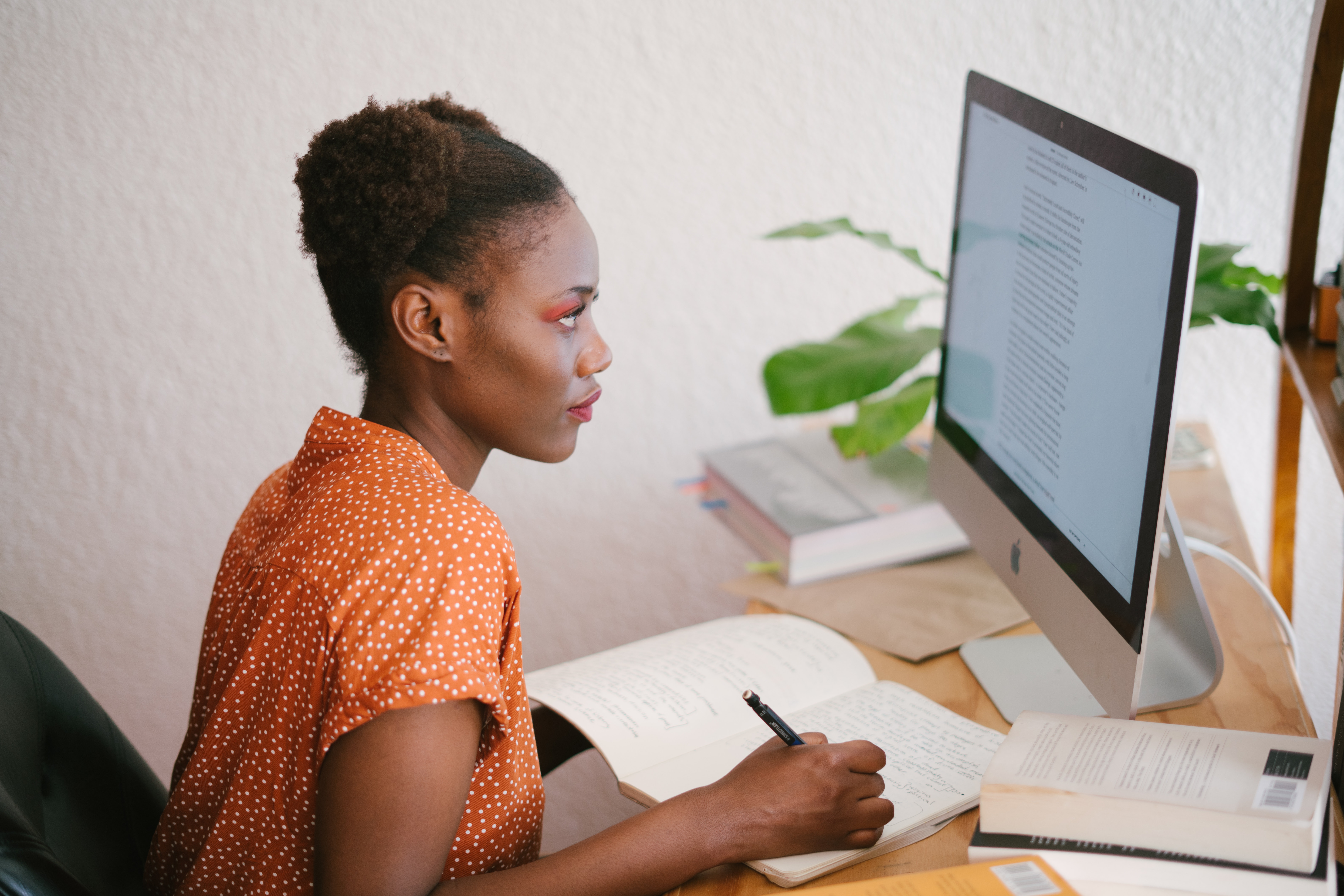 Woman doing work on a computer.