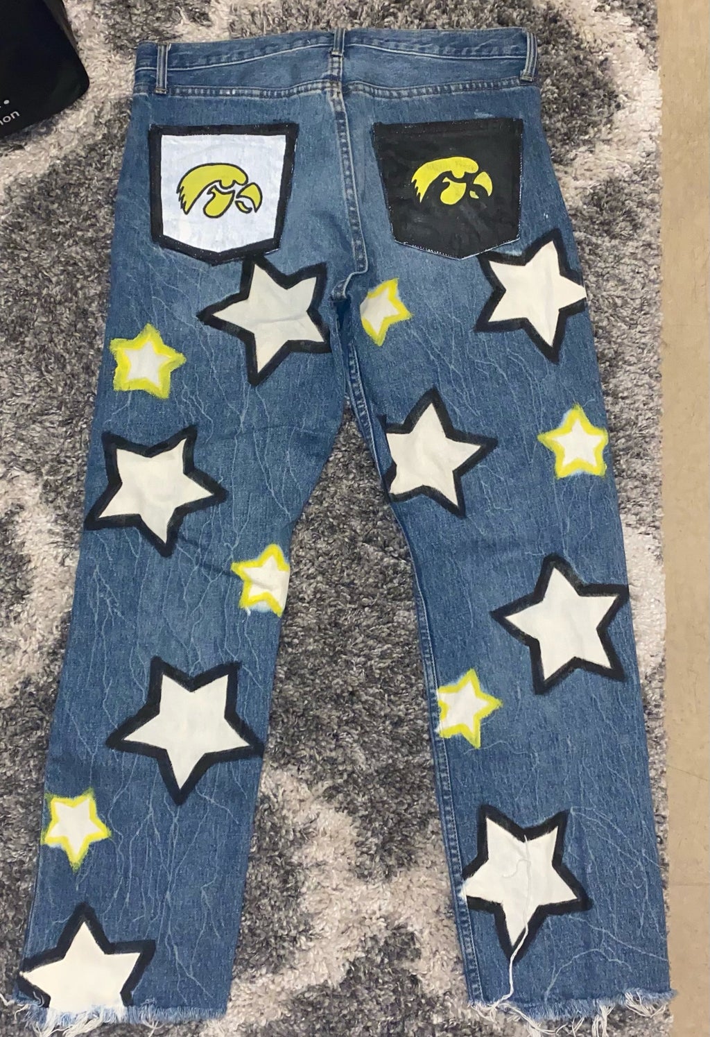 painted blue jeans with stars and hawkeyes