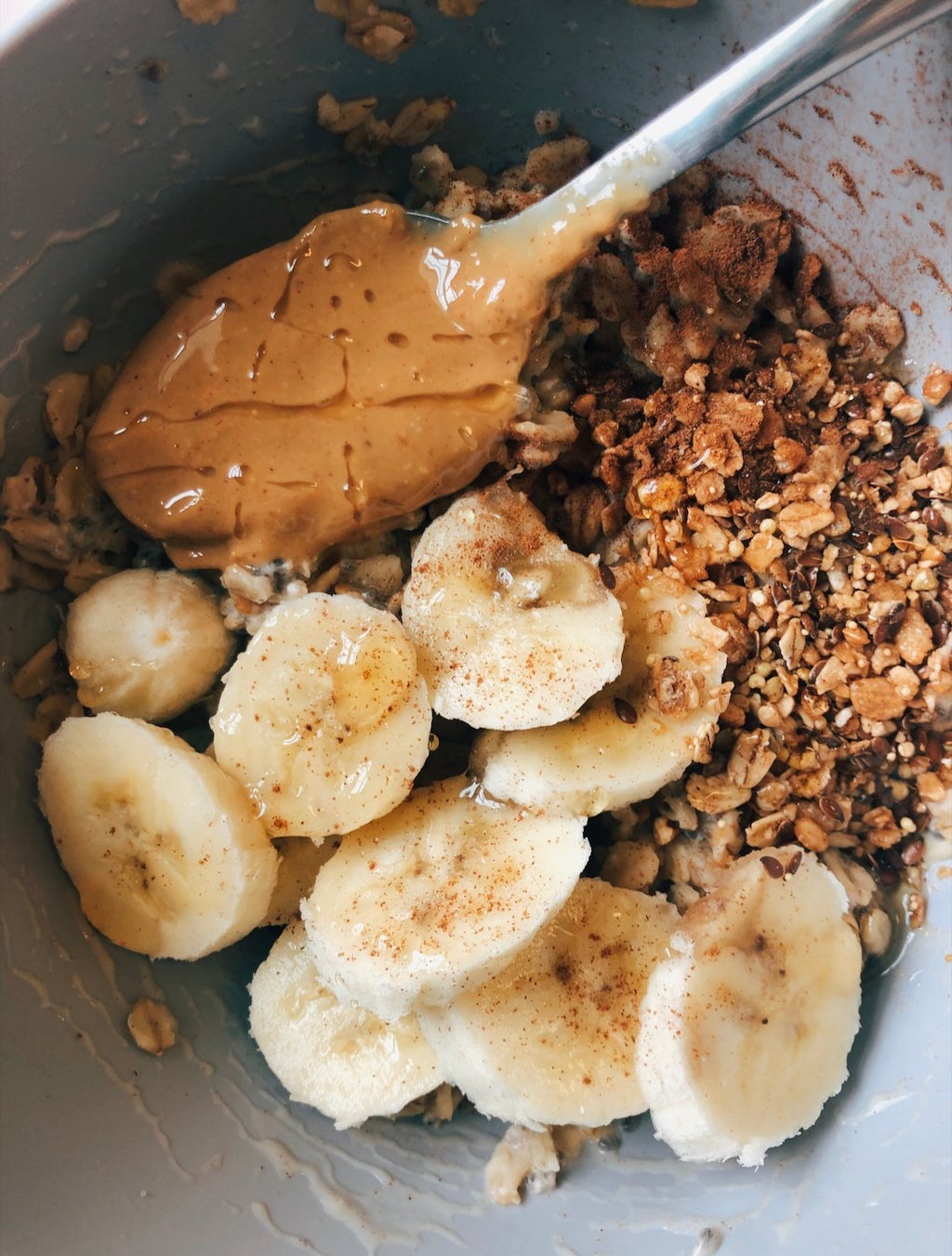 dorm oatmeal with bananas and nut butter. There is a spoon in it