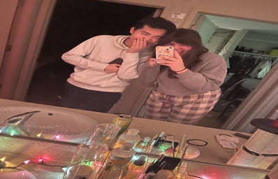 Two people laughing in mirror selfie