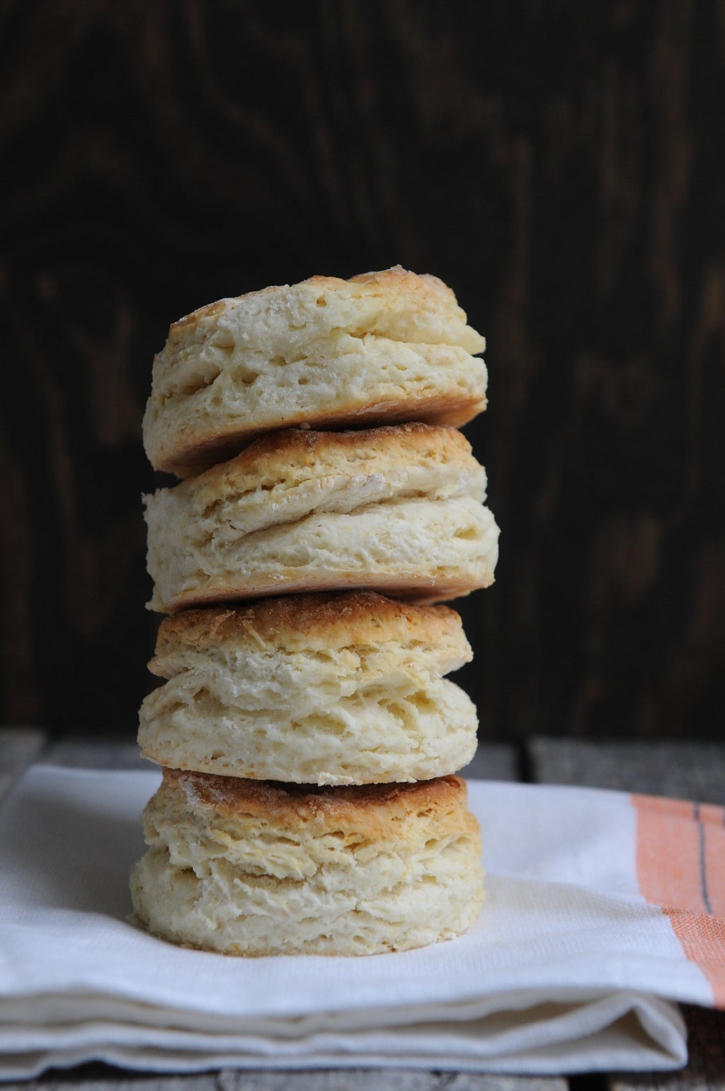 stack of four biscuits on cloth on table