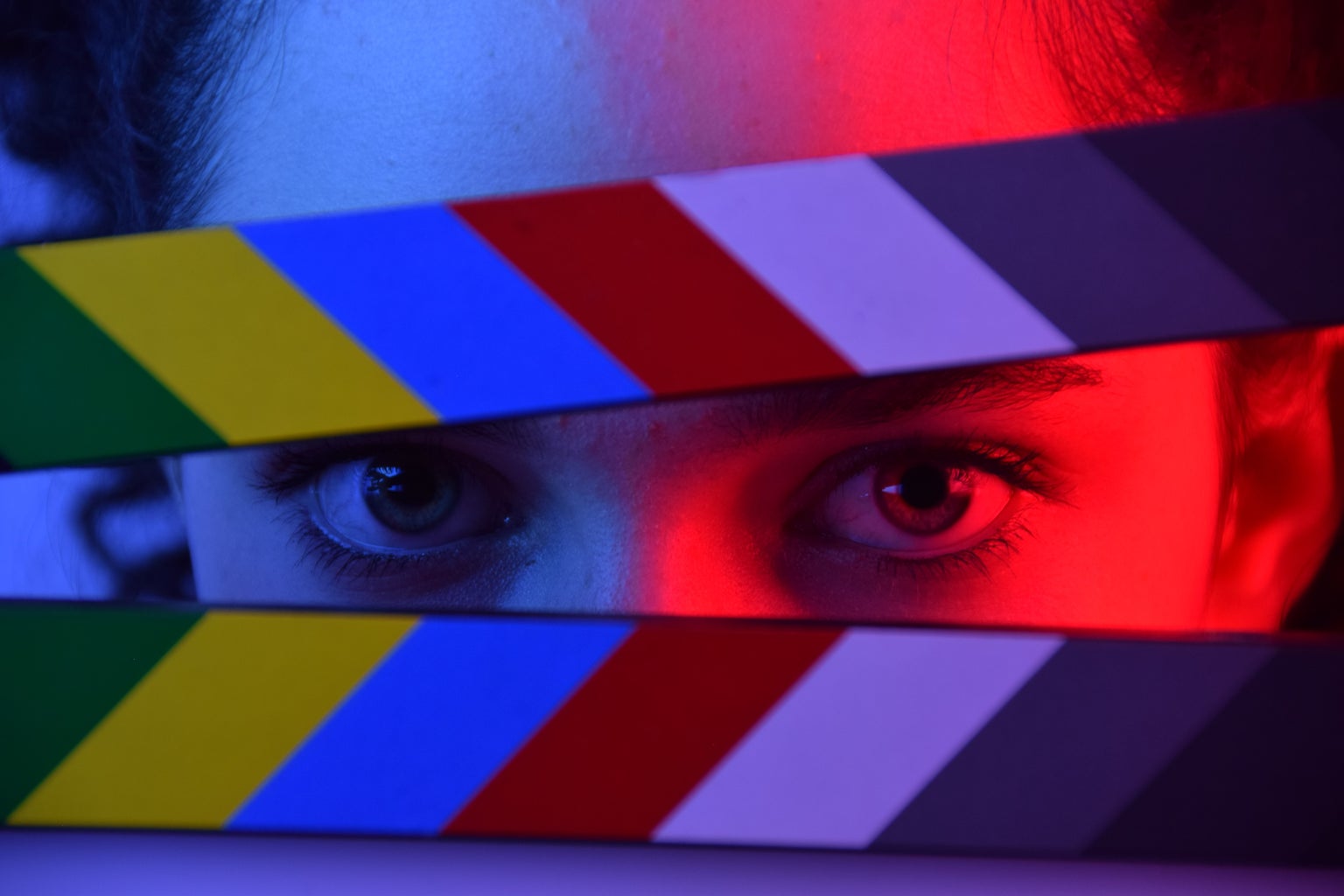 girl\'s eyes with film clapperboard