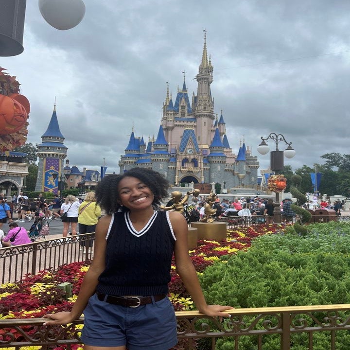 Maleyah standing in front of Disney\'s castle