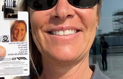 Woman\'s (Mariana Becker) selfie with her F1 pass while working.