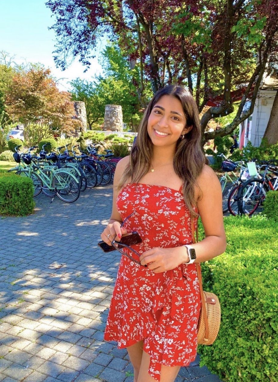 Girl smiling in red dress by Maddie Burke