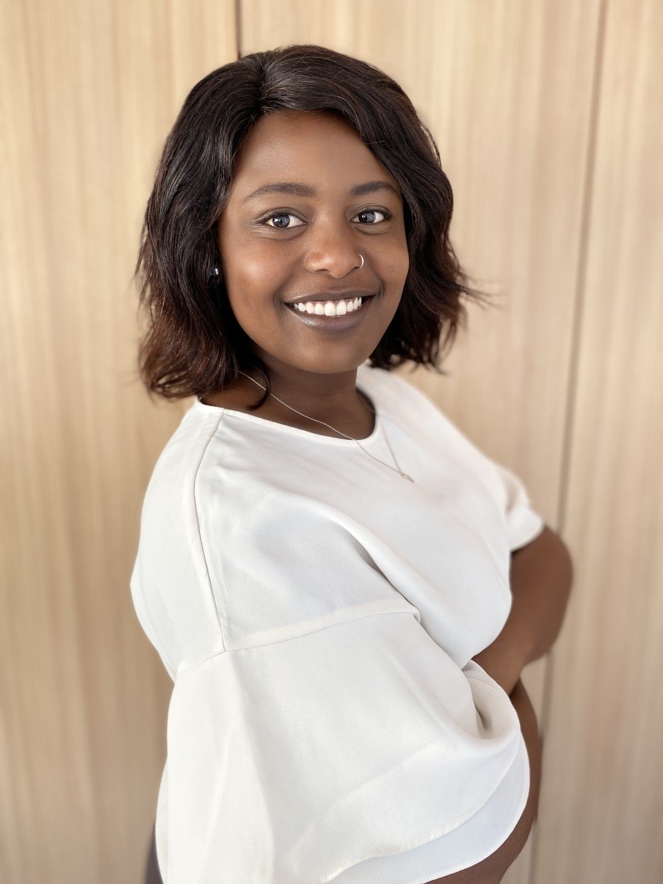 Tess Yieke side profile smiling in white top