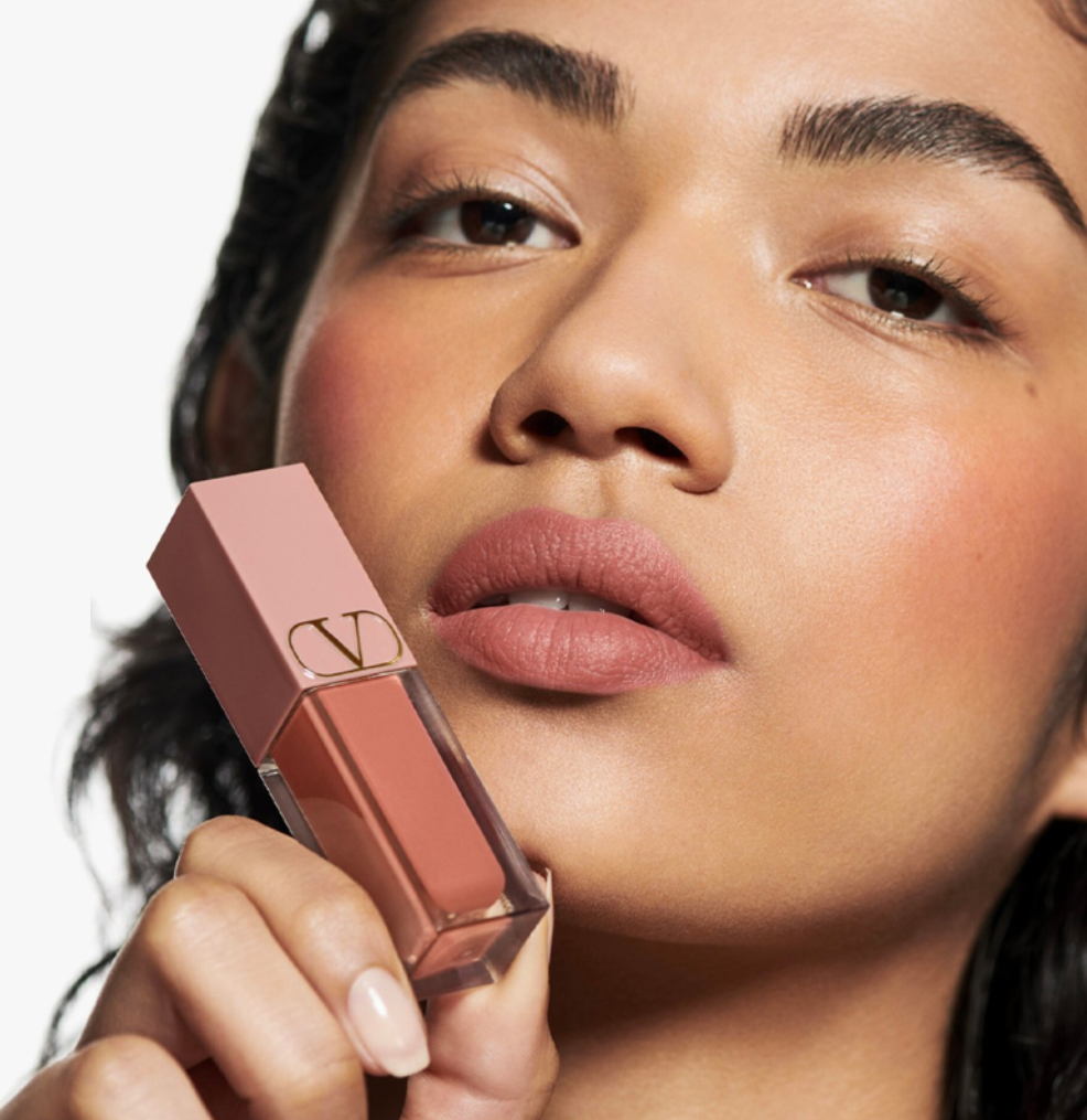 model wearing Valentino Beauty lip color in front of a white background
