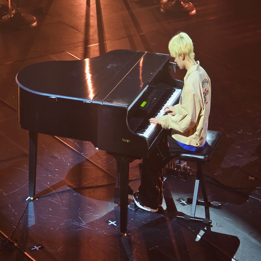 person playing piano on stage