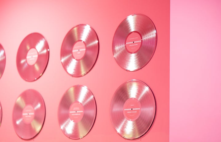 Pink vinyl records on a wall.