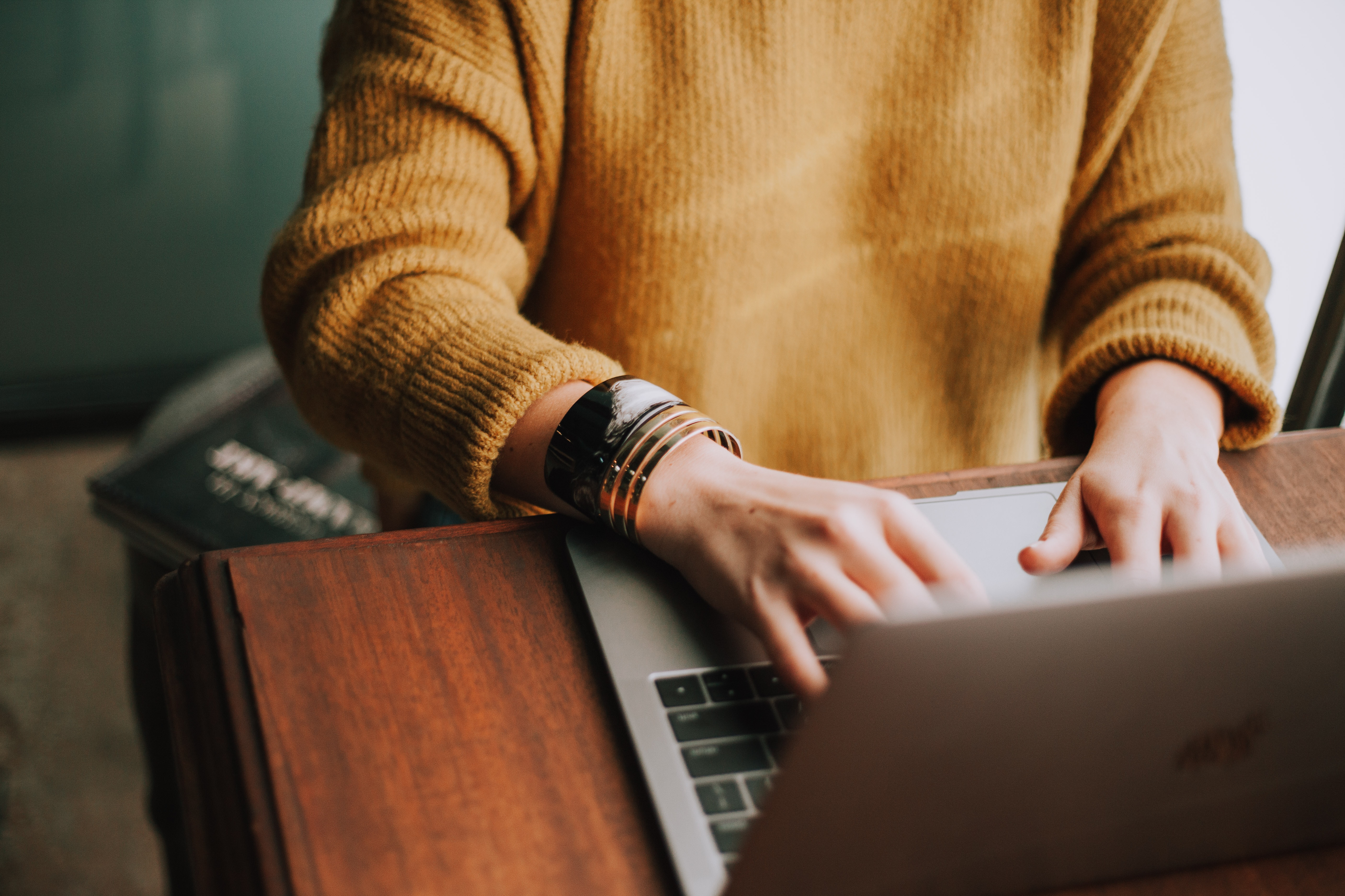 woman at desk typing on computer