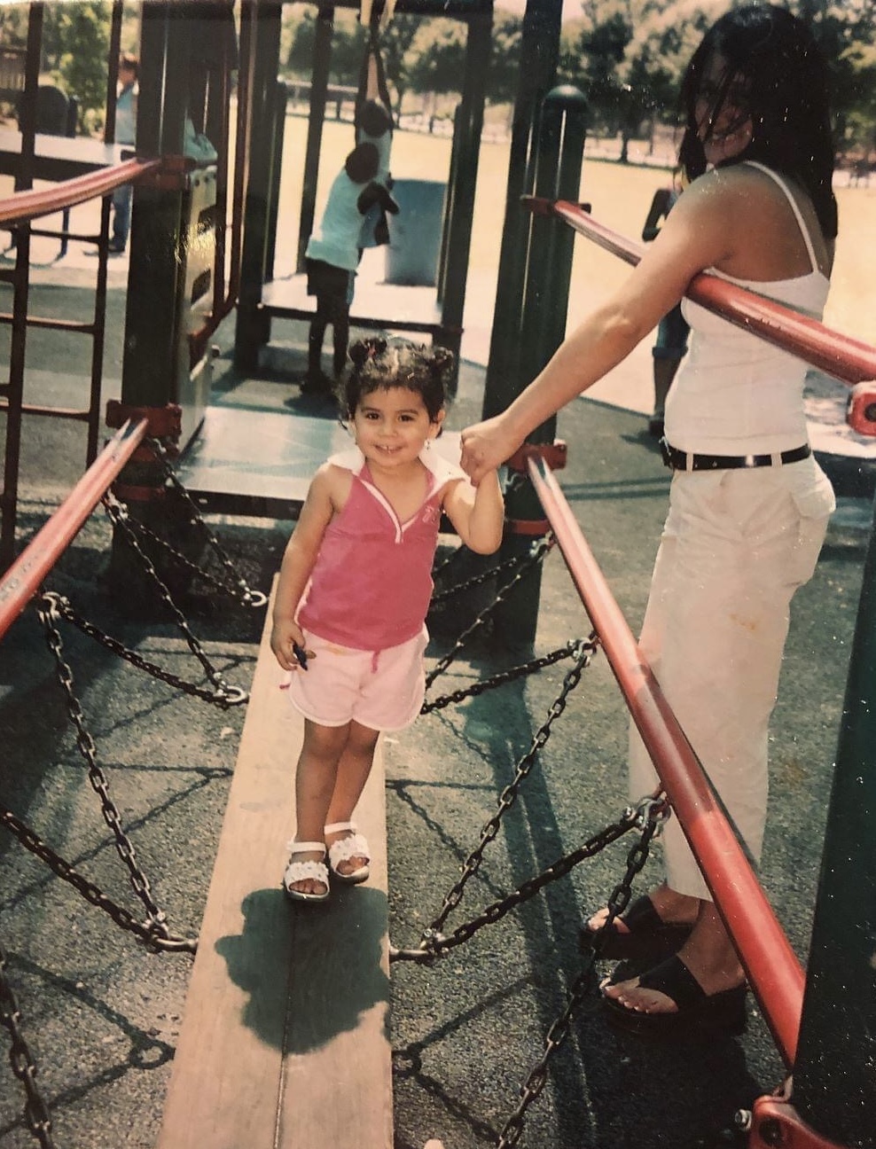 mother and daughter holding hands at the playground