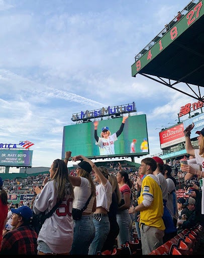 Dr. Mary Boyd on the big screen at Fenway Park after throwing the first pitch on her Inauguration Day as Emmanuel President at the Red Sox Game