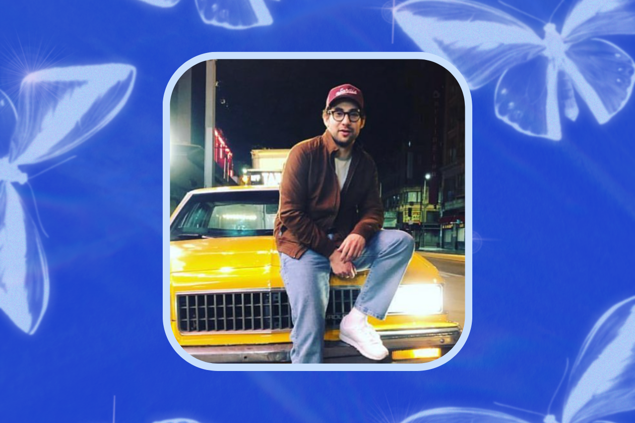 Jack Antonoff posing by a car.