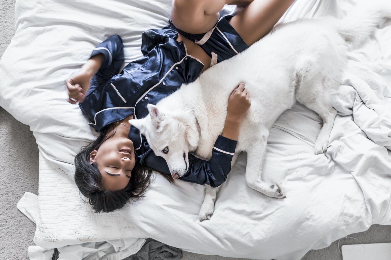 Pajamas, fashion: Please help support by following @dayinmydreams on Instagram xoxo Girl lies comfortably in a white bed in luxury blue silk pajamas, hugging her best friend white husky dog. This is the kind of happiness people live for.