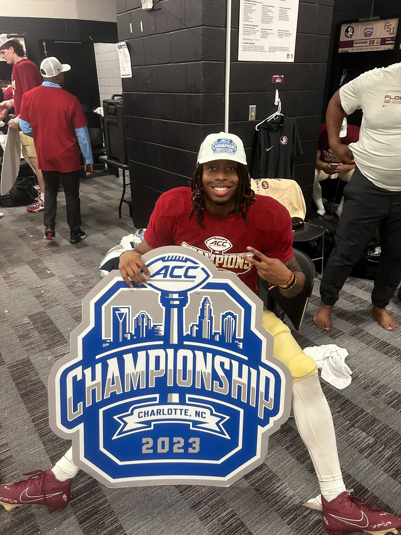 jaden floyd holding national championship sign