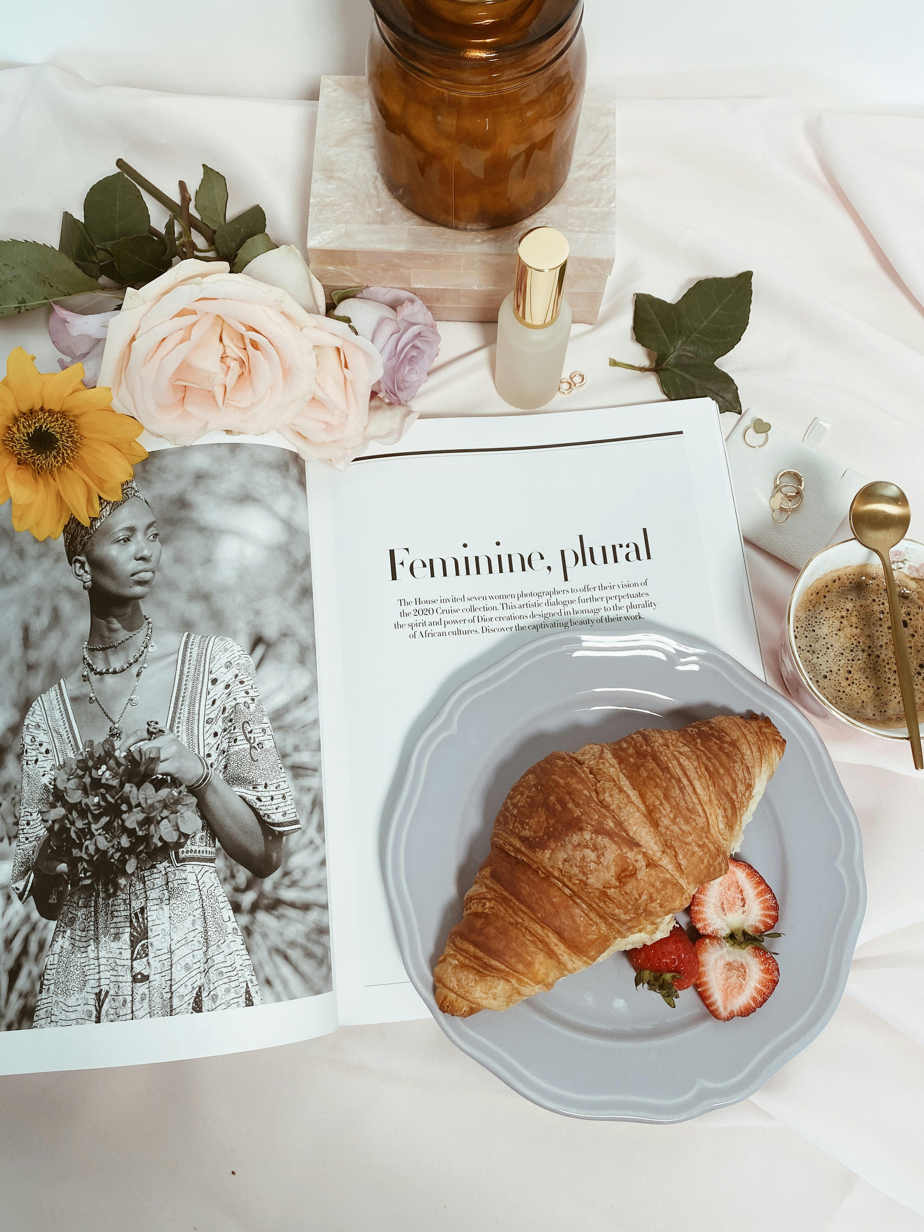 Breakfast table with flowers & girl magazine