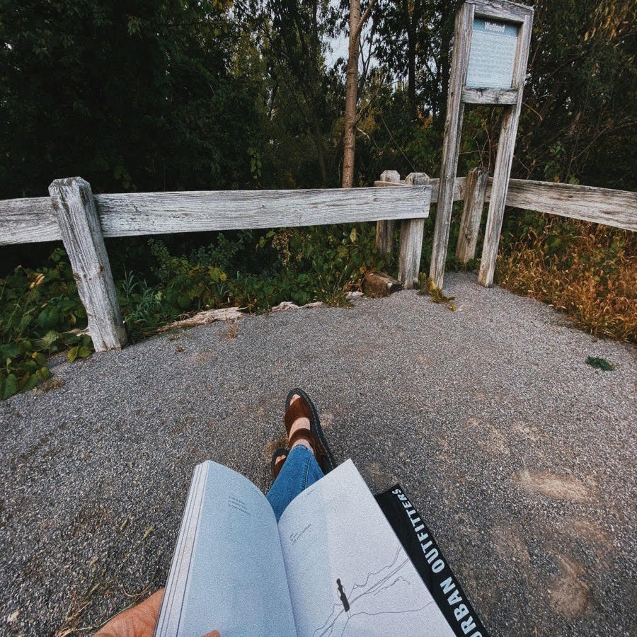 Sitting on a bench reading a book
