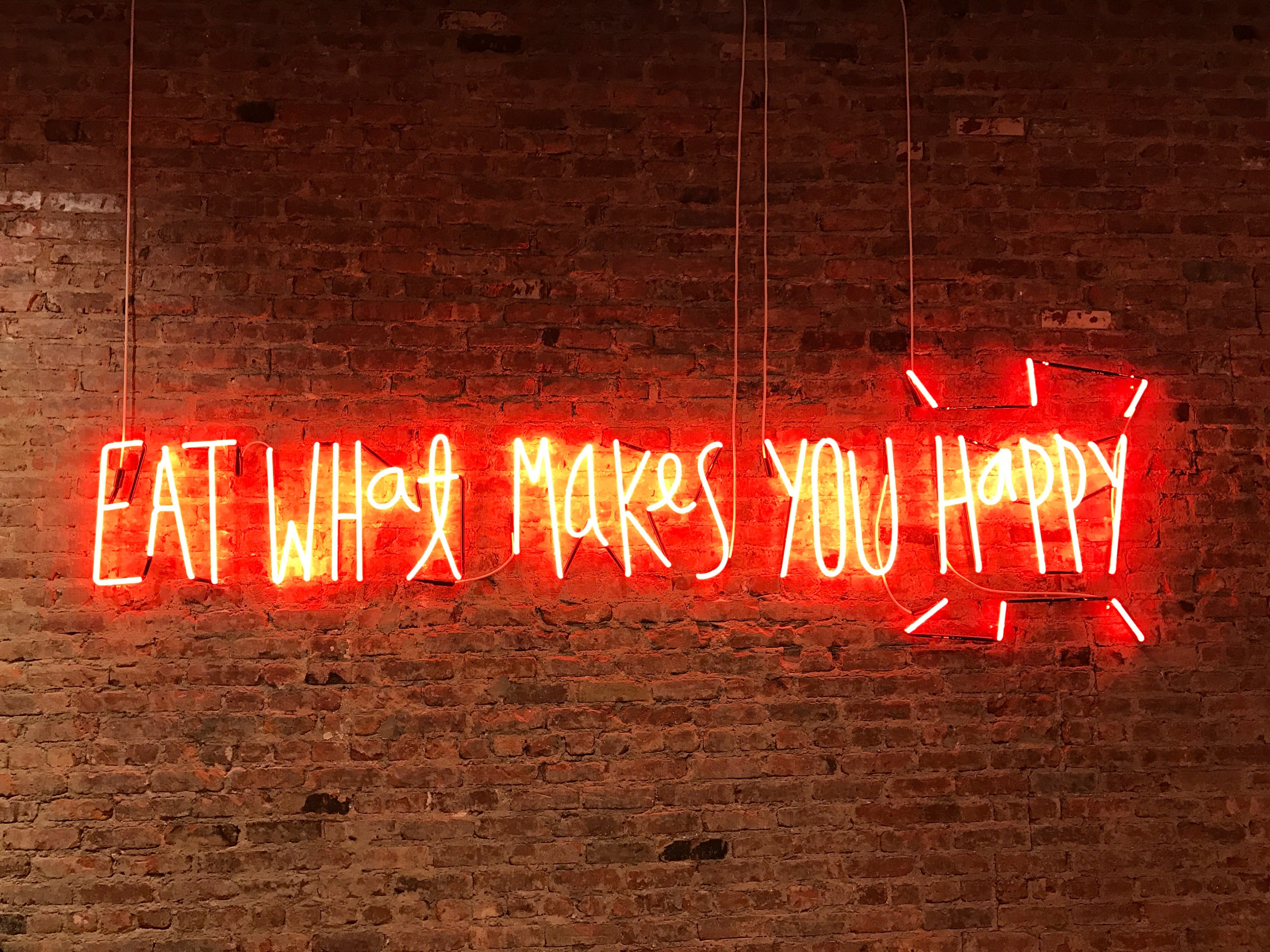 eat what makes you happy neon sign by Jon Tyson?width=698&height=466&fit=crop&auto=webp&dpr=4