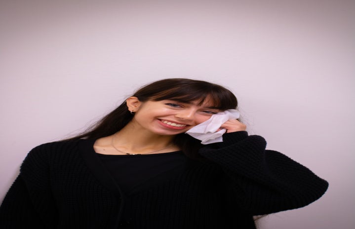 Woman wiping off makeup