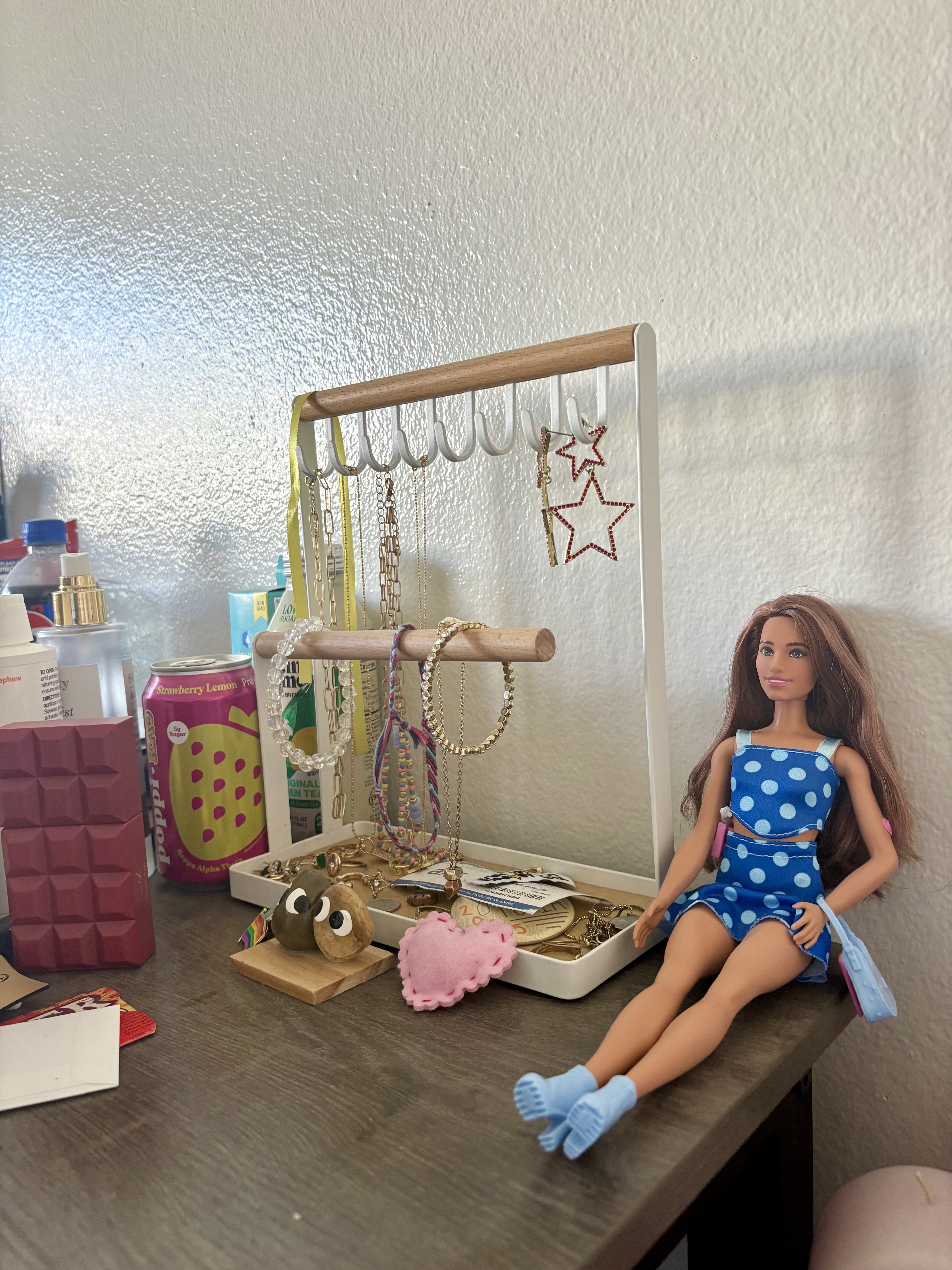 Barbie sitting on desk.