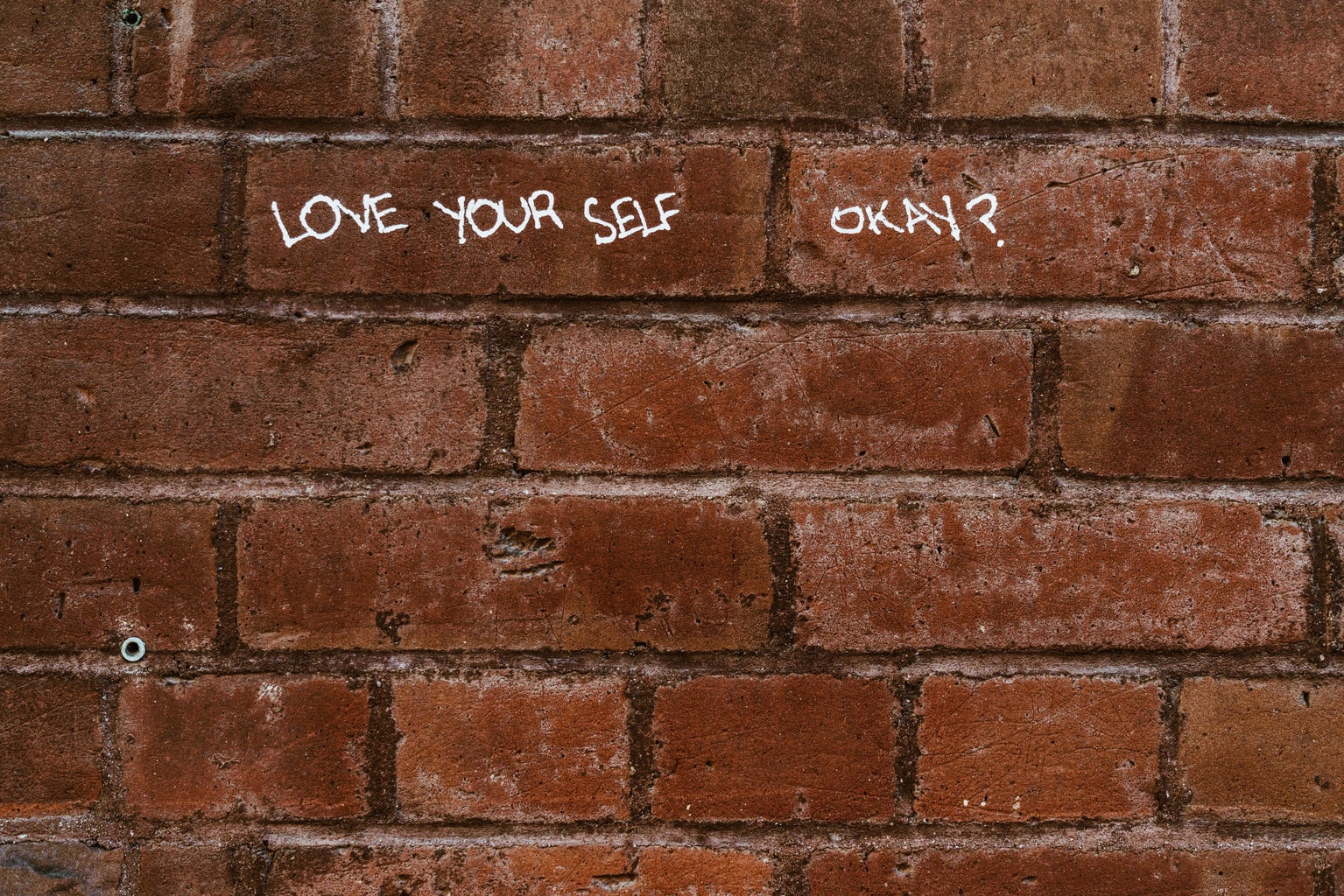 Love yourself written on wall