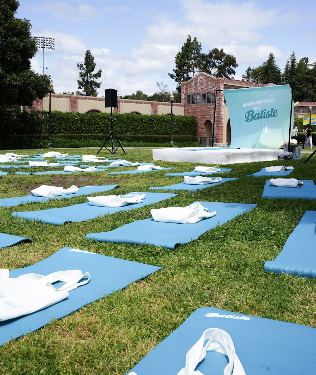 Blue yoga mats on the grass on UCLA\'s campus.