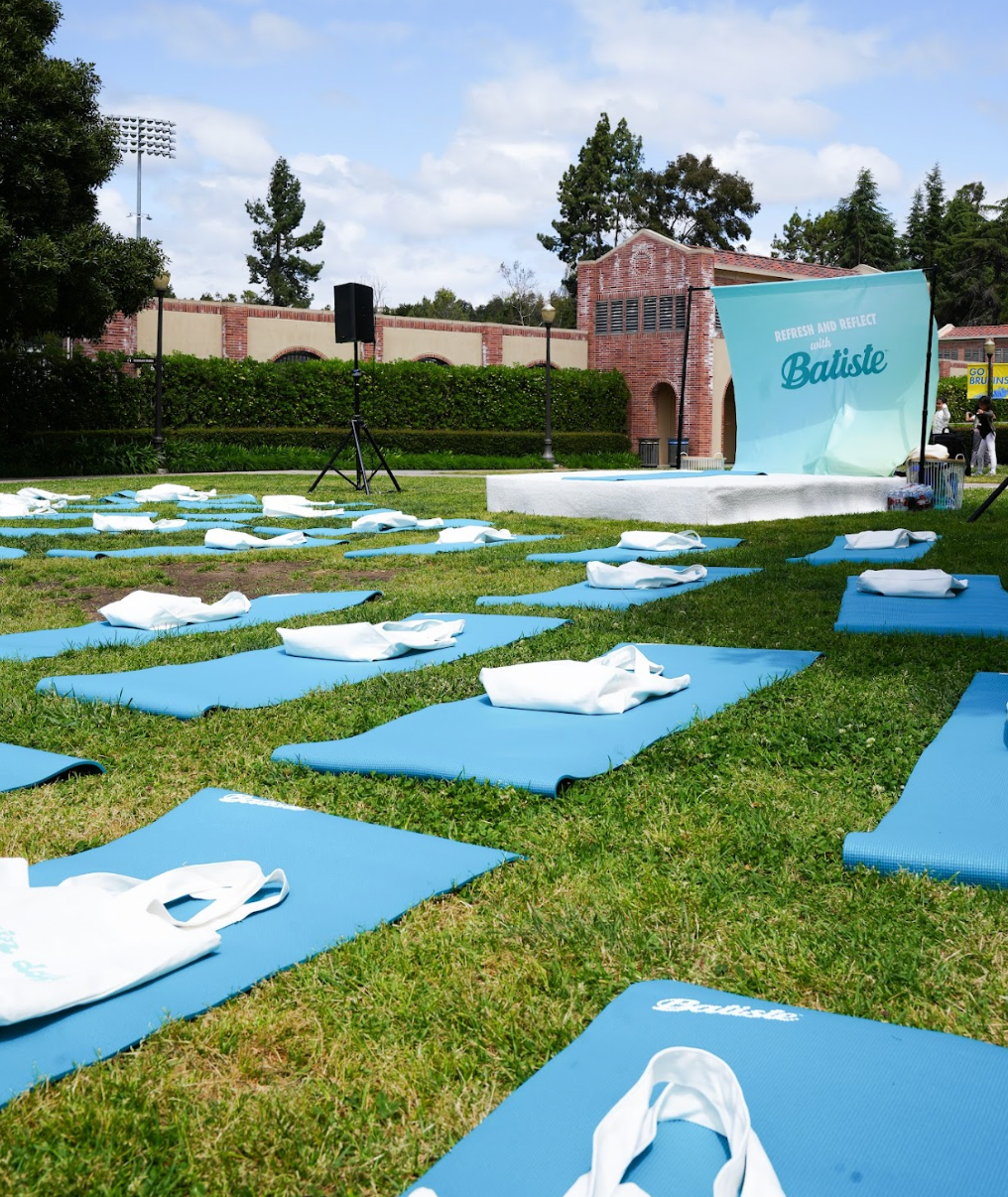 Blue yoga mats on the grass on UCLA\'s campus.