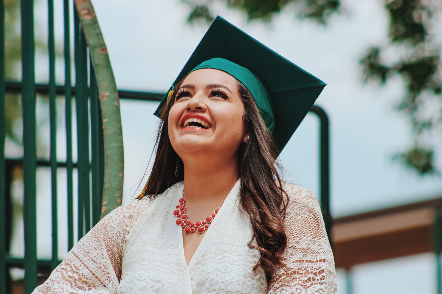 woman wearing green graduation cap