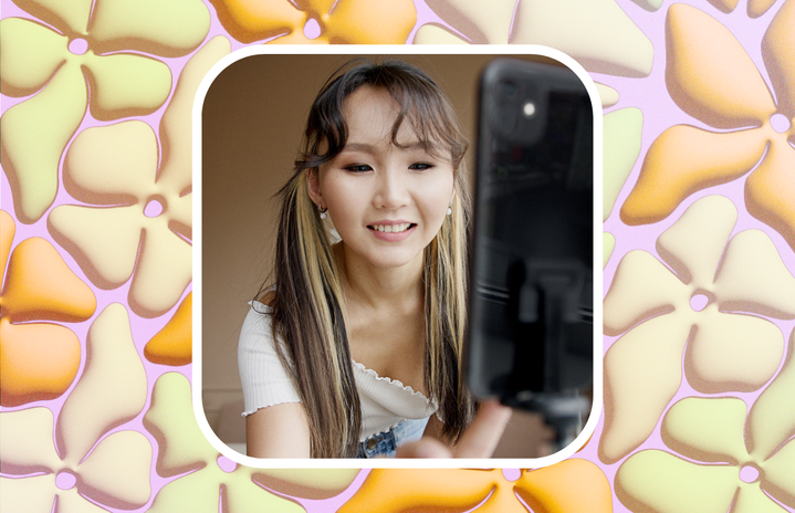 smiling girl filming video on phone