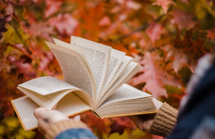 Person holding book in fall