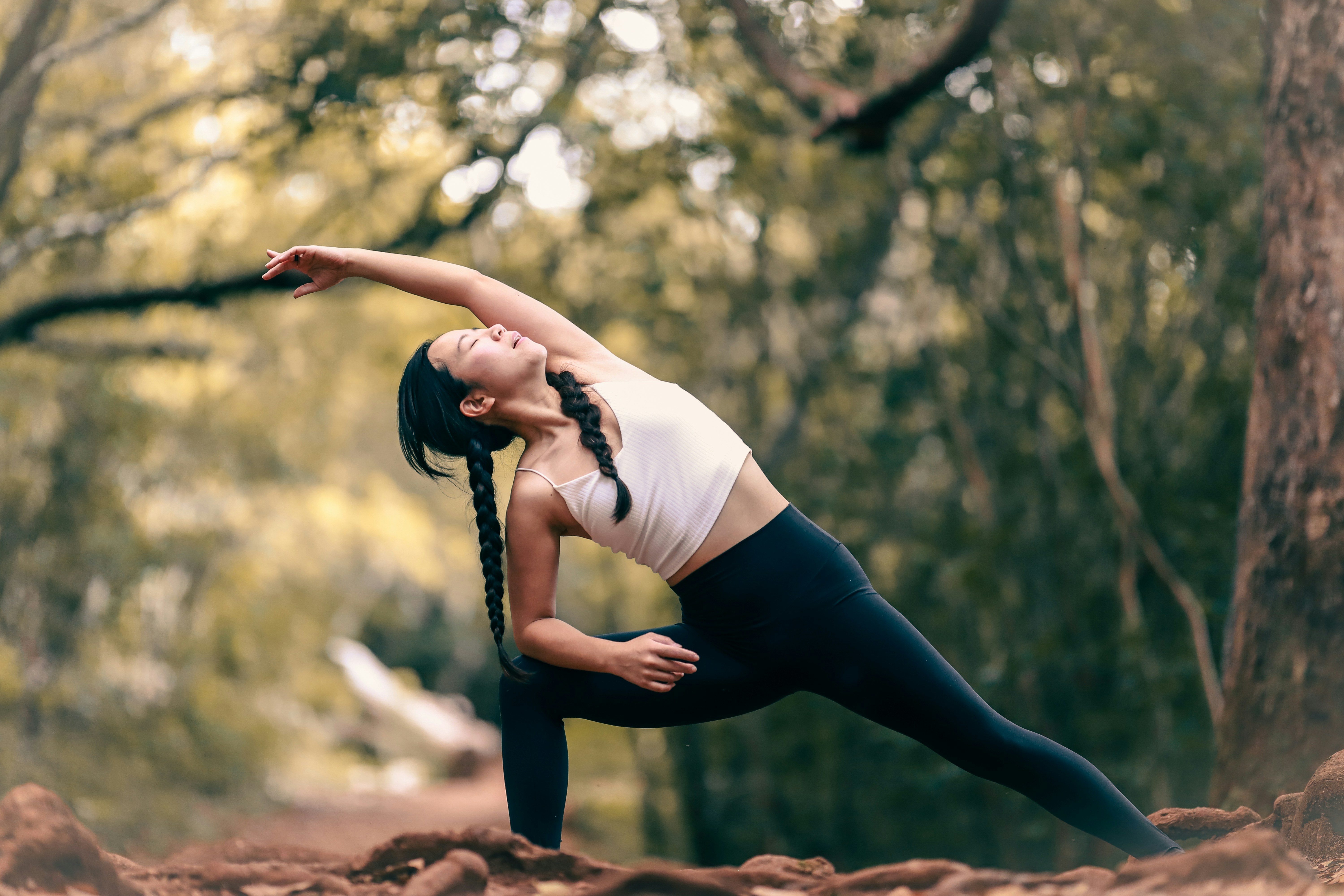 woman stretching in woods