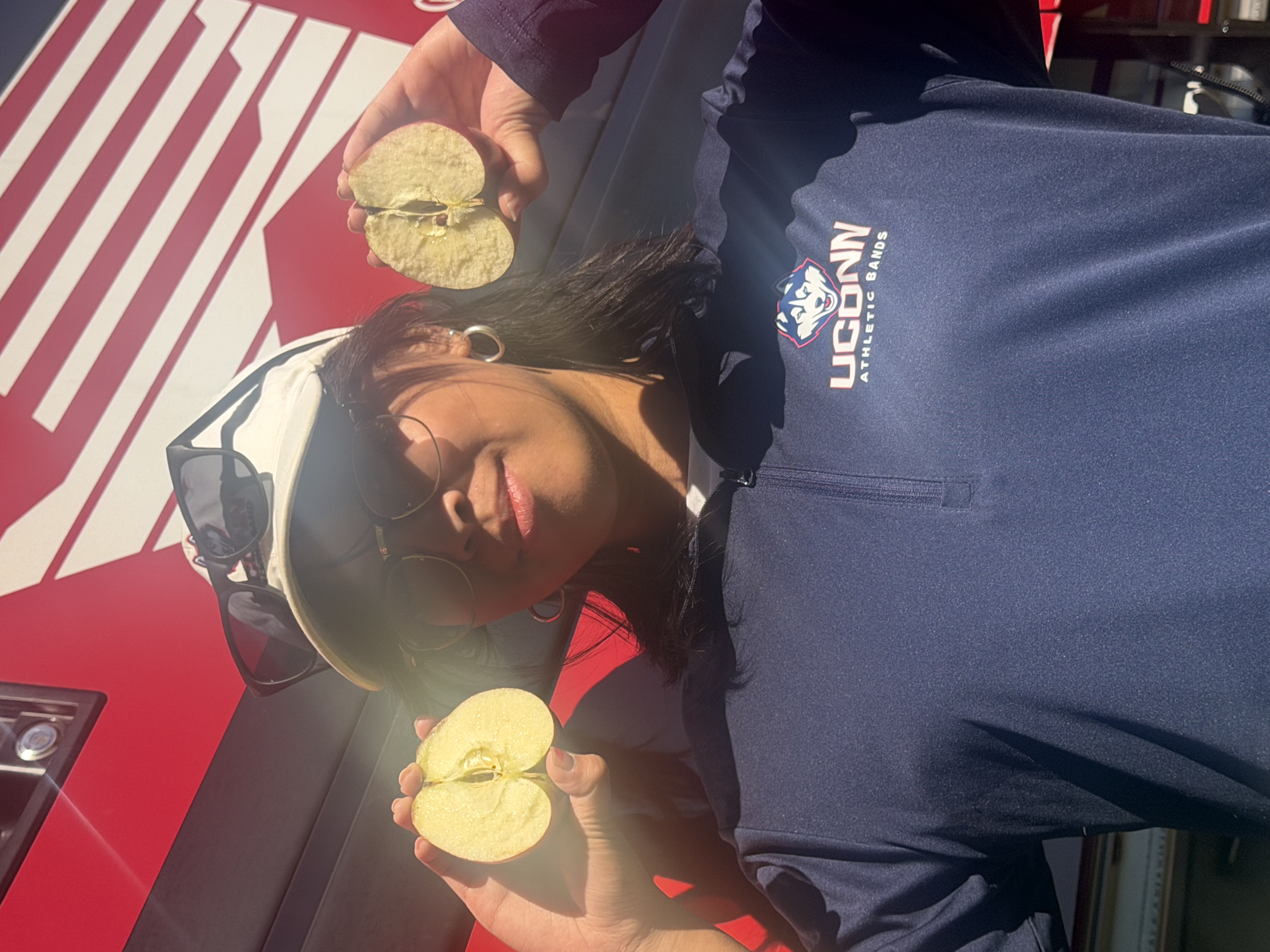 Jenny Zhao splitting an apple in half