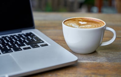 coffee on table next to laptop