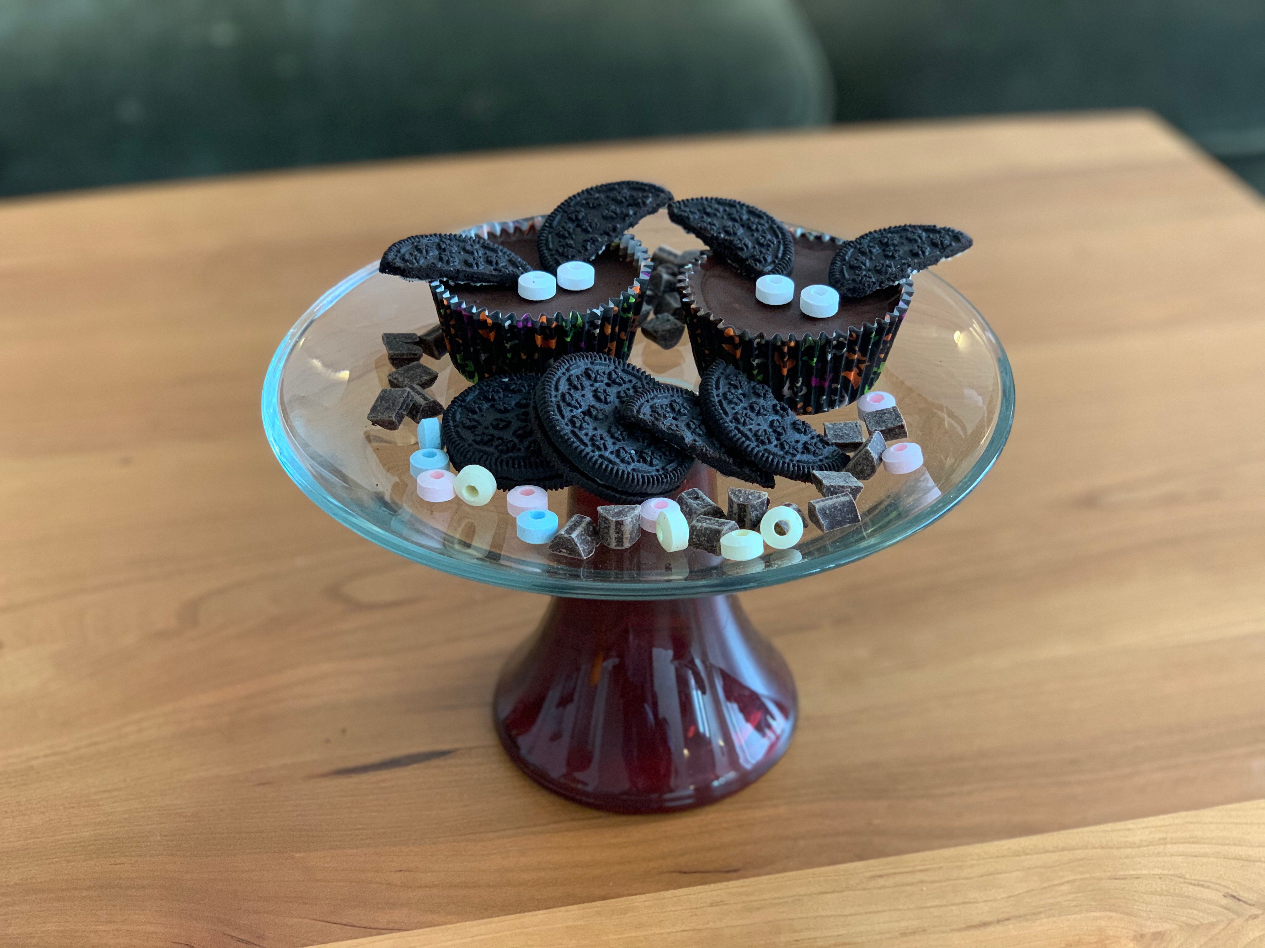 Bat shaped peanut butter cups among strewn out ingredients.