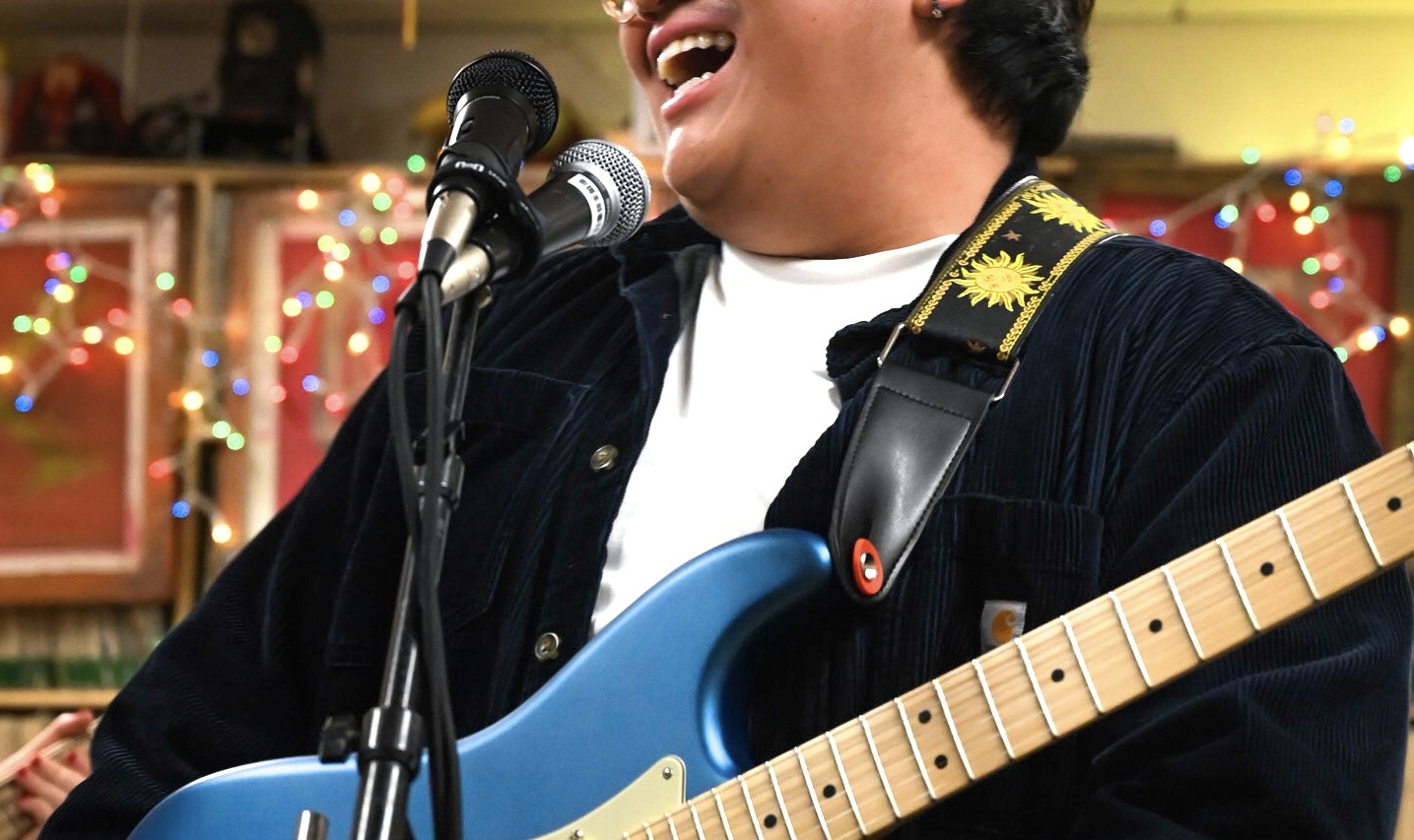 image of man singing in front of microphone