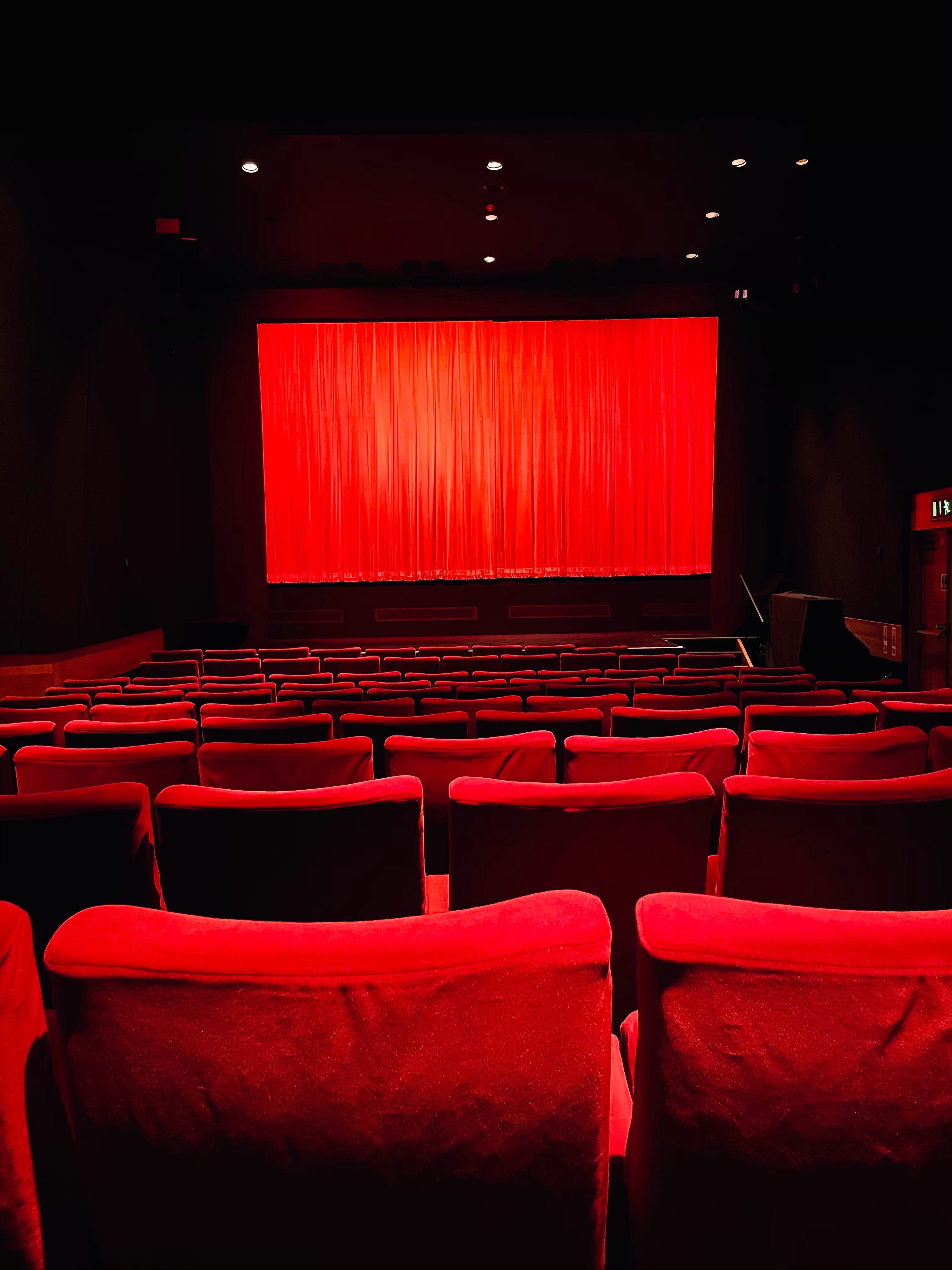 a theatre seen from above, with chairs and the curtain visible