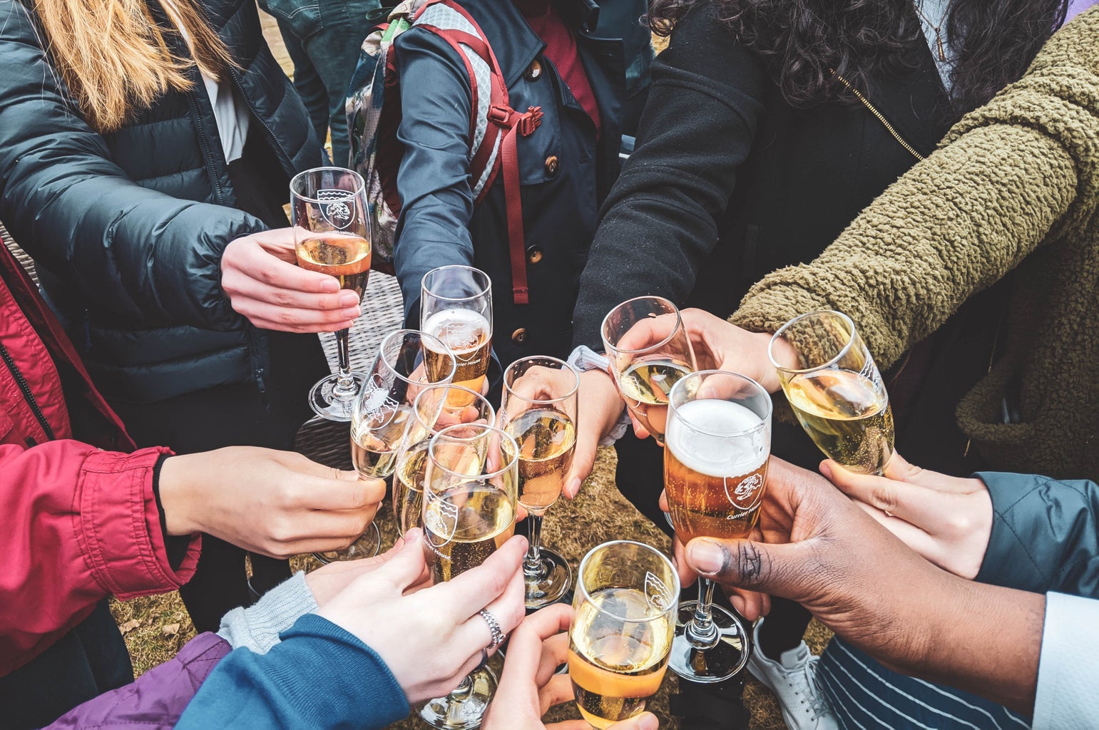 people holding champagne glasses