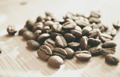 \"coffee beans on brown surface\"