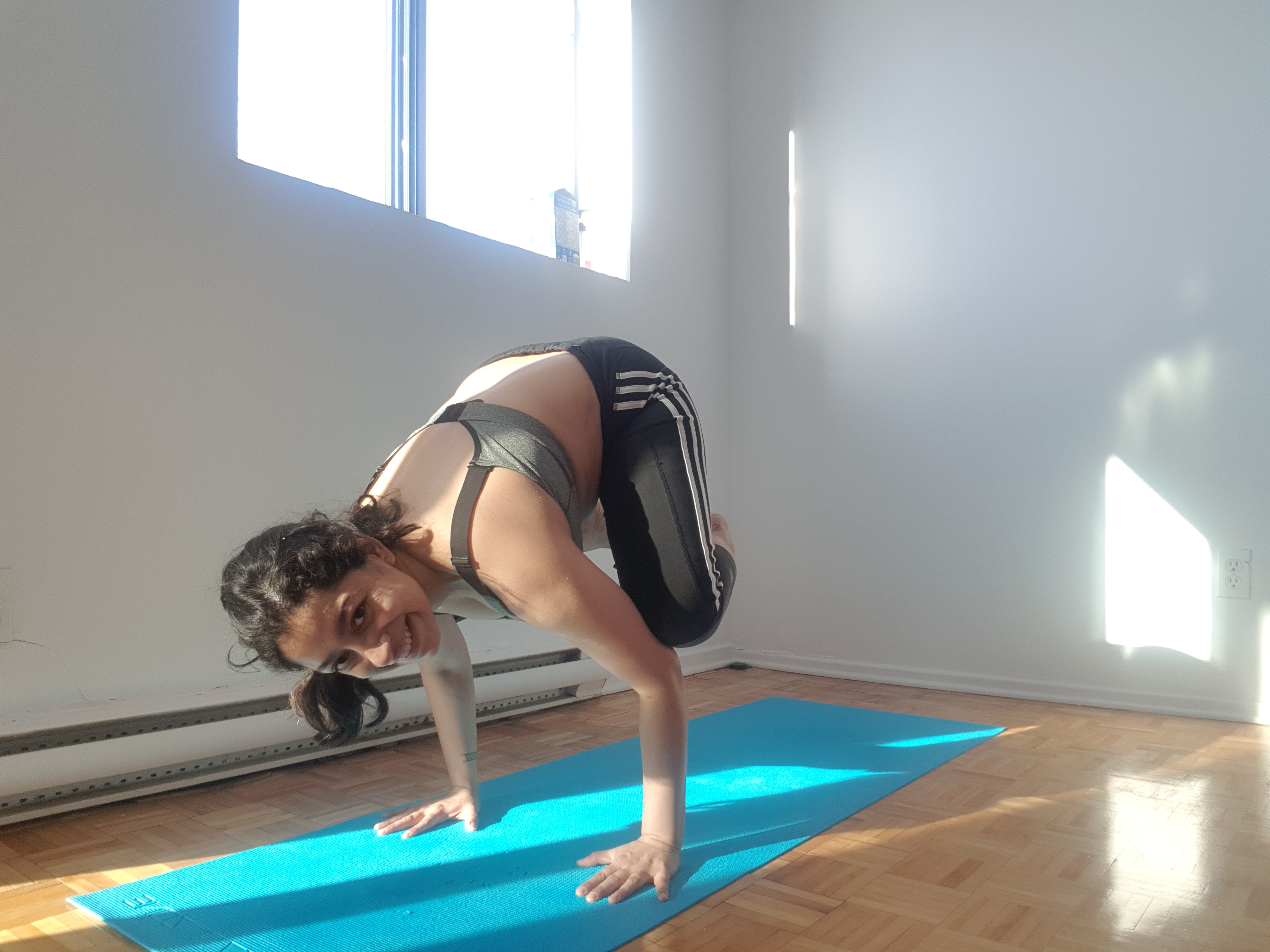 Woman in bakasana, in crow pose.