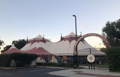 Photo of the gate to enter the FSU Flying High Circus center, with the tent in the background.