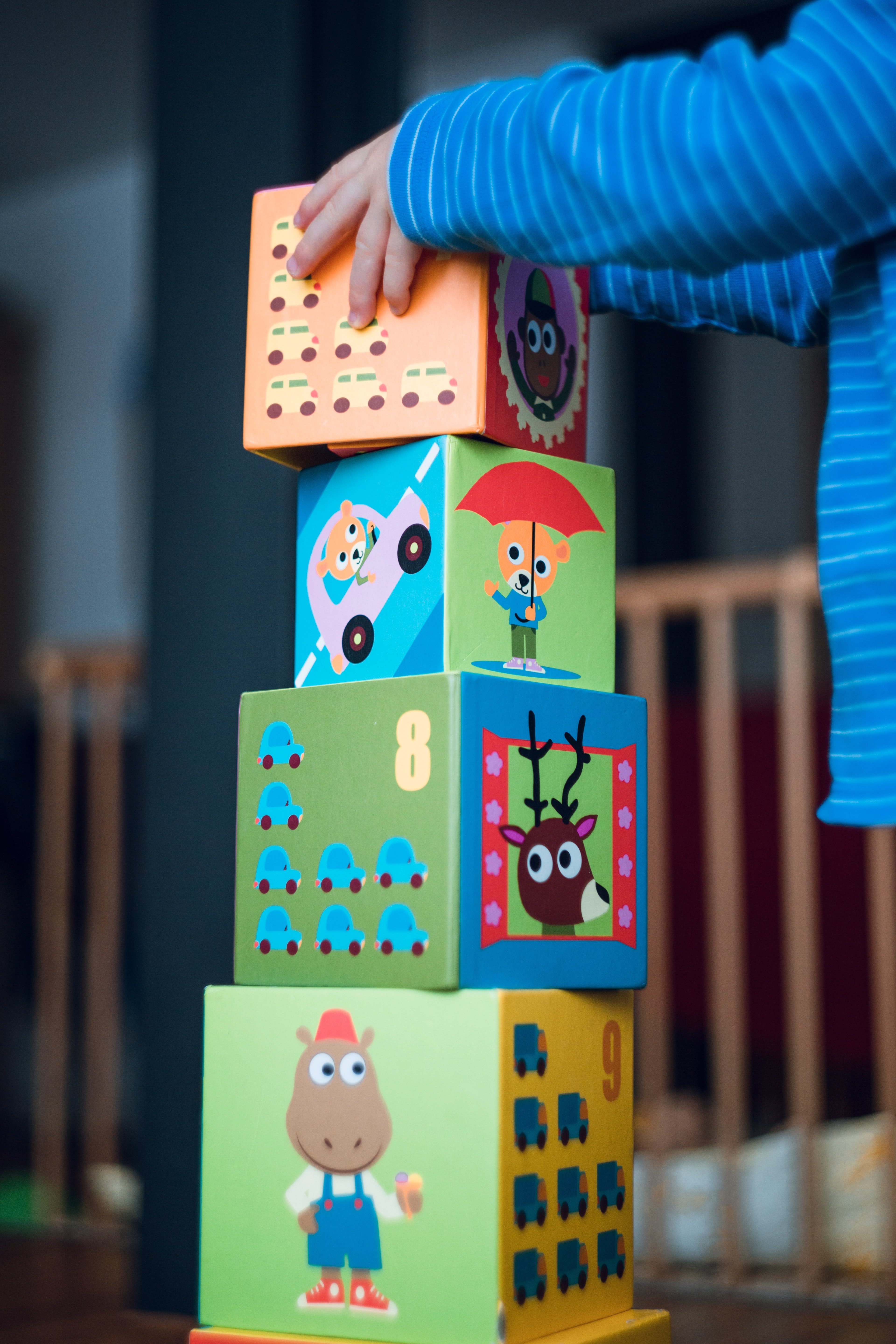 child playing with wooden blocks