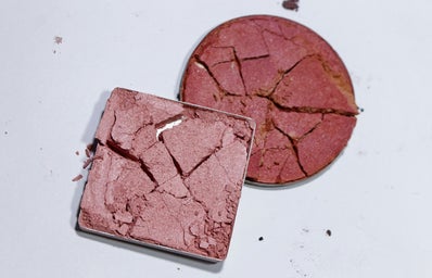 Two crushed makeup powders laying over one another.