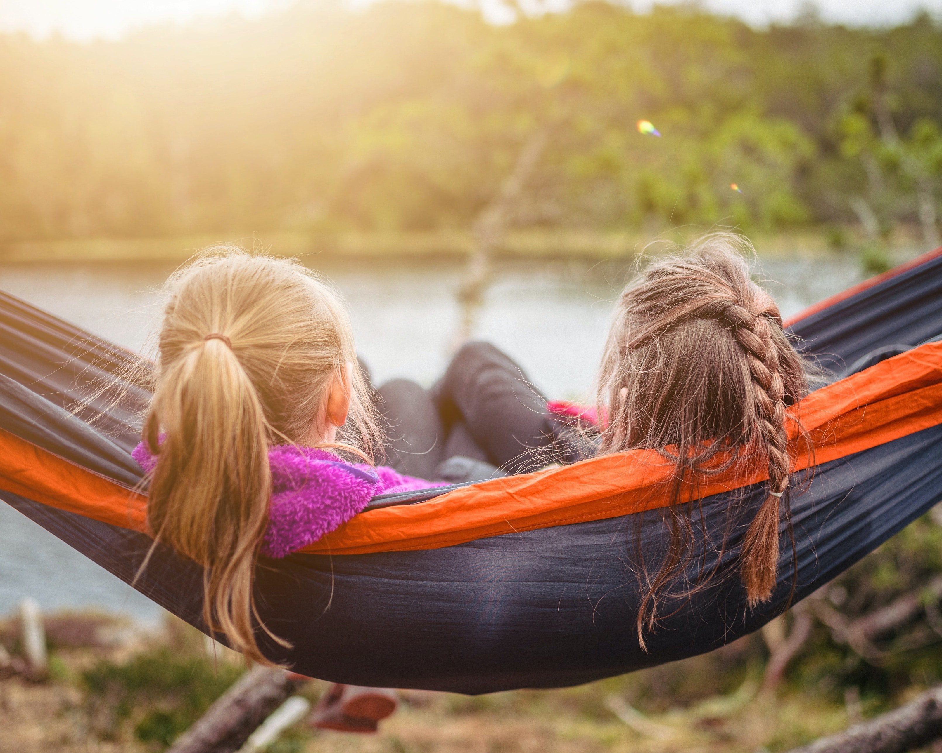Friends sitting in hammock together by Janko Ferli from Unsplash