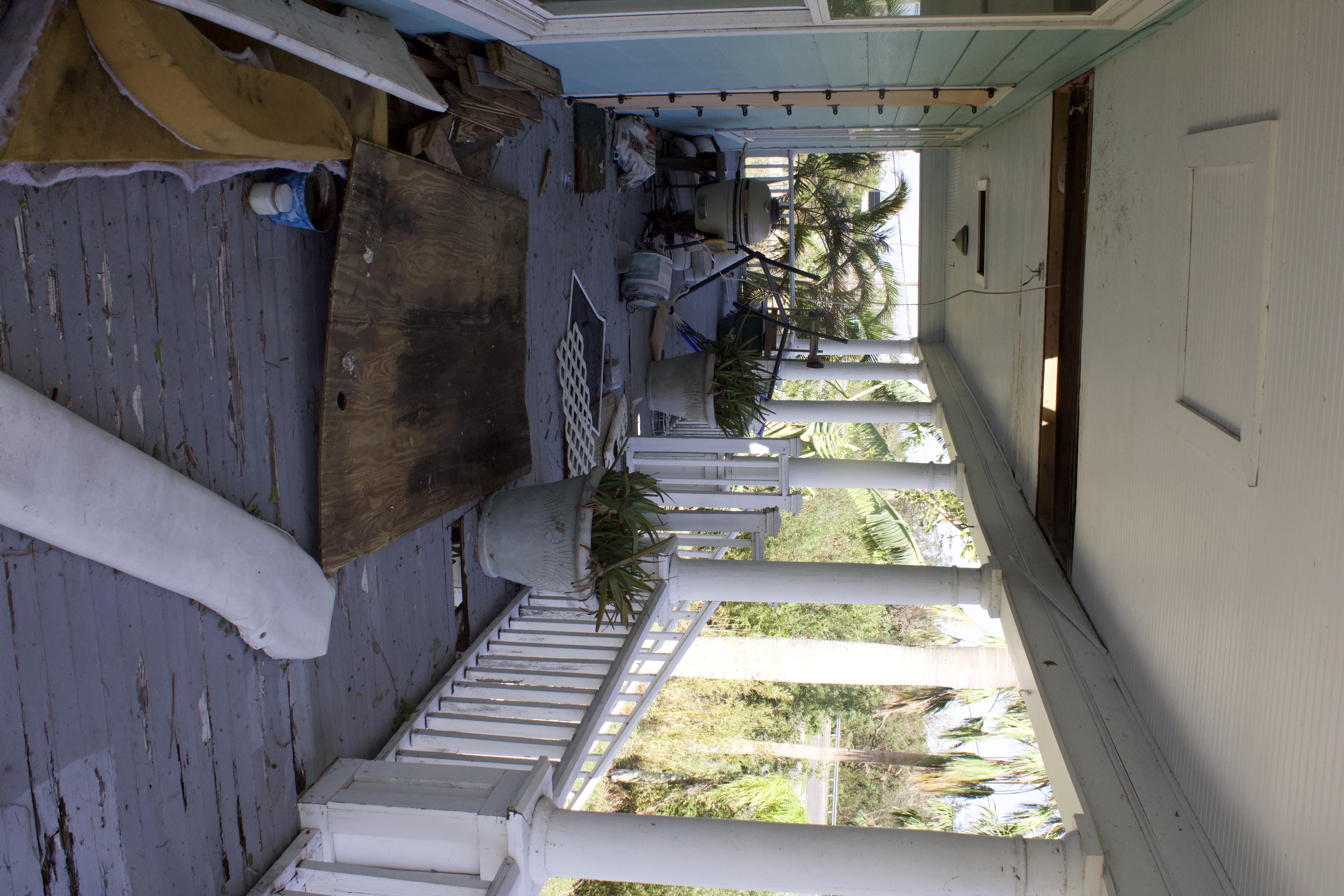 Front porch of house with debris