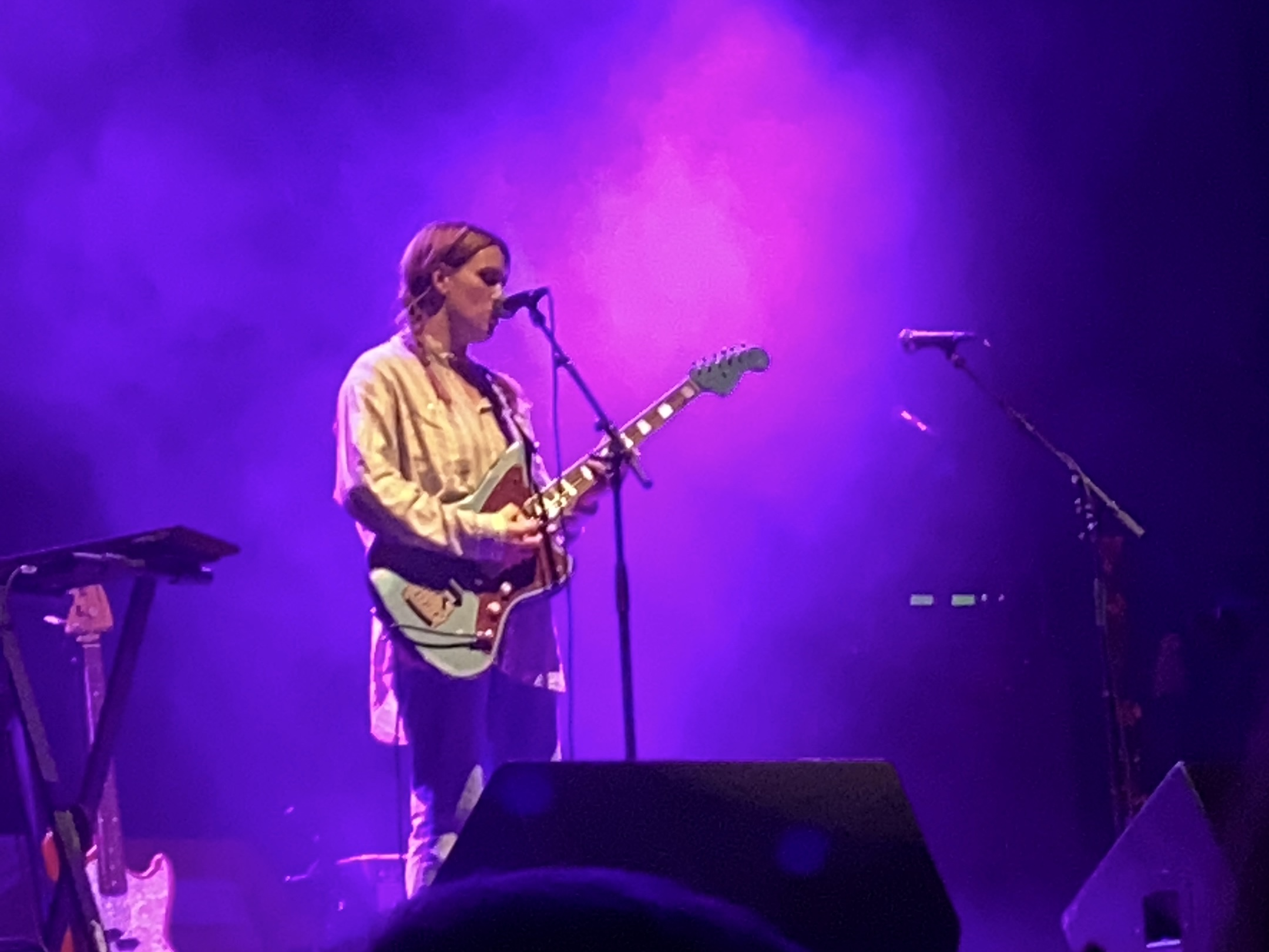 Musician singing and playing guitar.