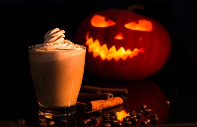 Jack o Lantern with Chocolate Drink on Brown Wooden Table